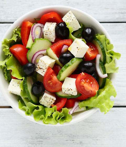 Fresh Greek salad in a bowl, top view.jpg